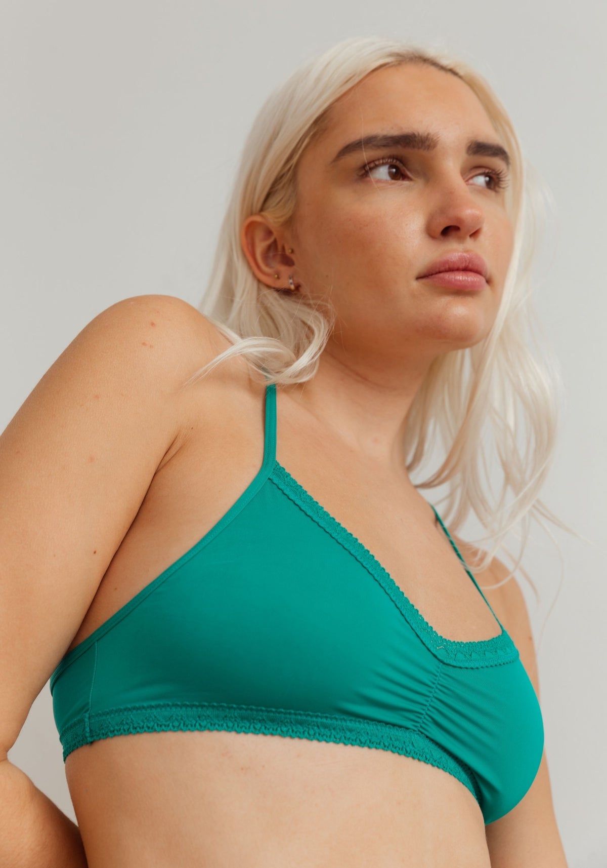 model is wearing an S bralette-green the micro lace trim bralette