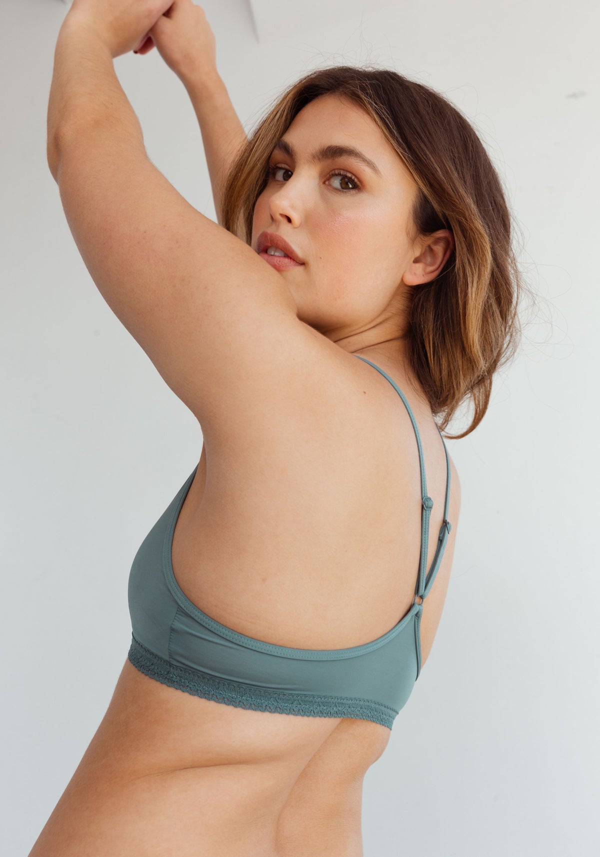 model is wearing an S bralette-green the micro lace trim bralette