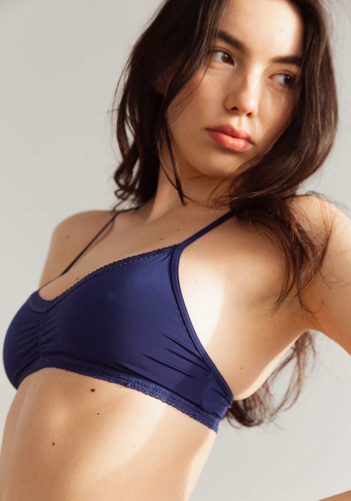 model is wearing an S bralette - blue the micro lace trim bralette