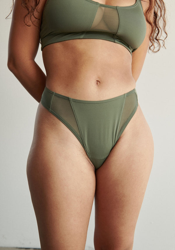 model is wearing an XS panty-green next thong