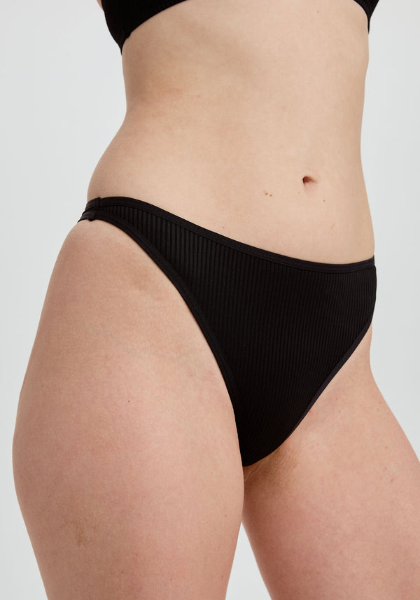 model is wearing an S panty - black the rib high leg thong