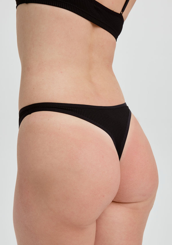 model is wearing an S panty - black the rib high leg thong
