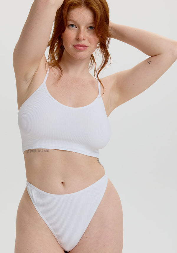 model is wearing an S panty - white the rib high leg thong