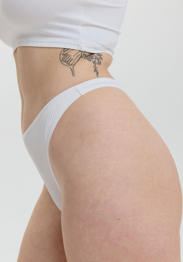 model is wearing an S panty - white the rib high leg thong