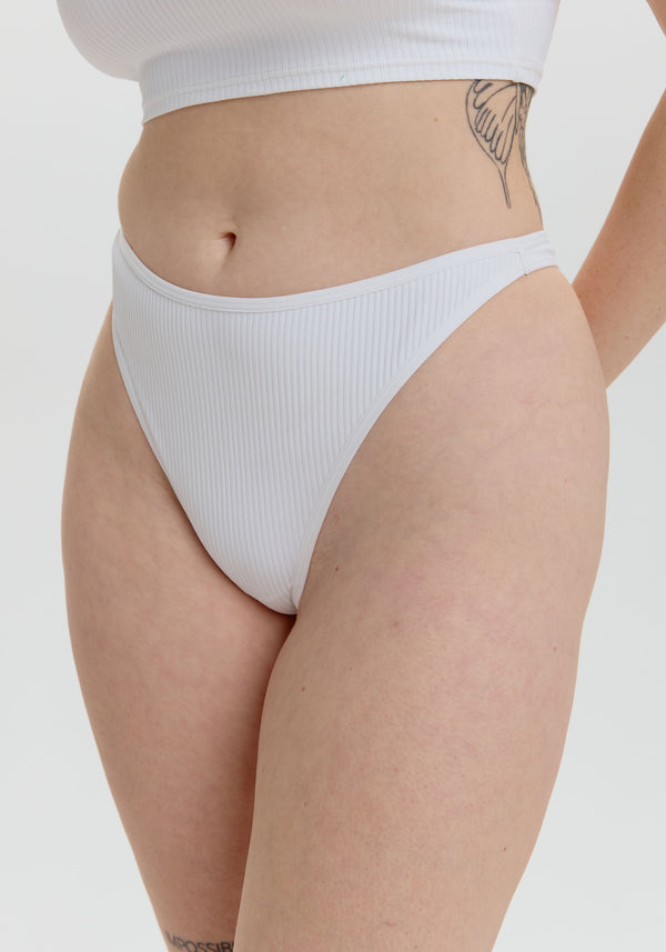model is wearing an S panty - white the rib high leg thong
