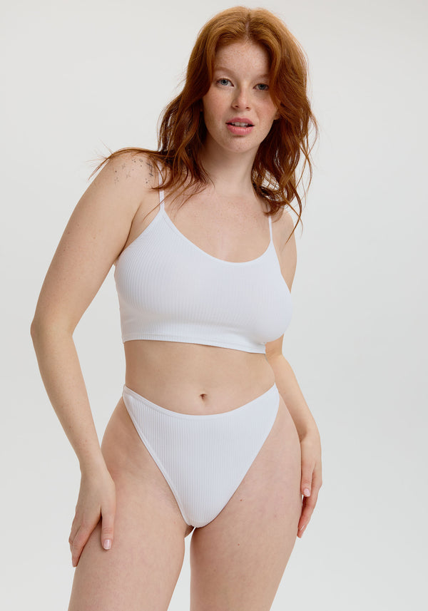 model is wearing an S panty - white the rib high leg thong