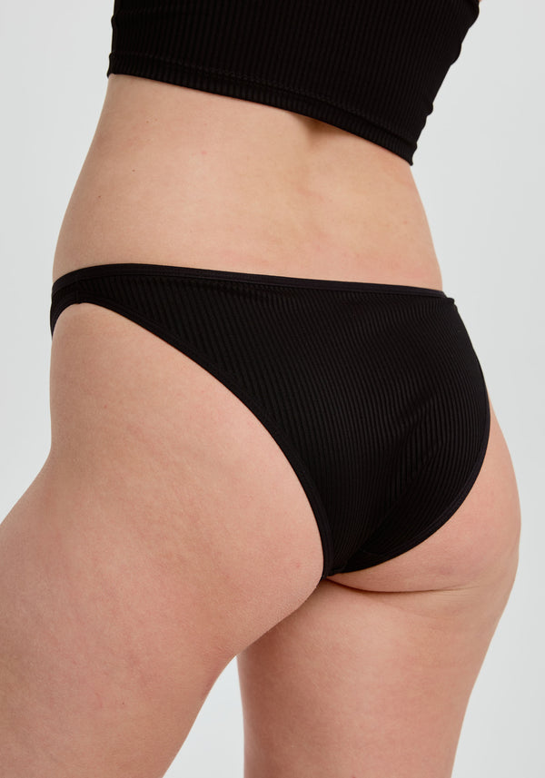 model is wearing an S panty - black the rib high leg bikini