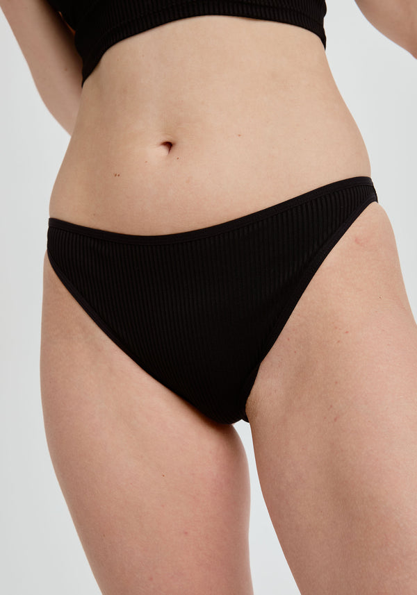 model is wearing an S panty - black the rib high leg bikini