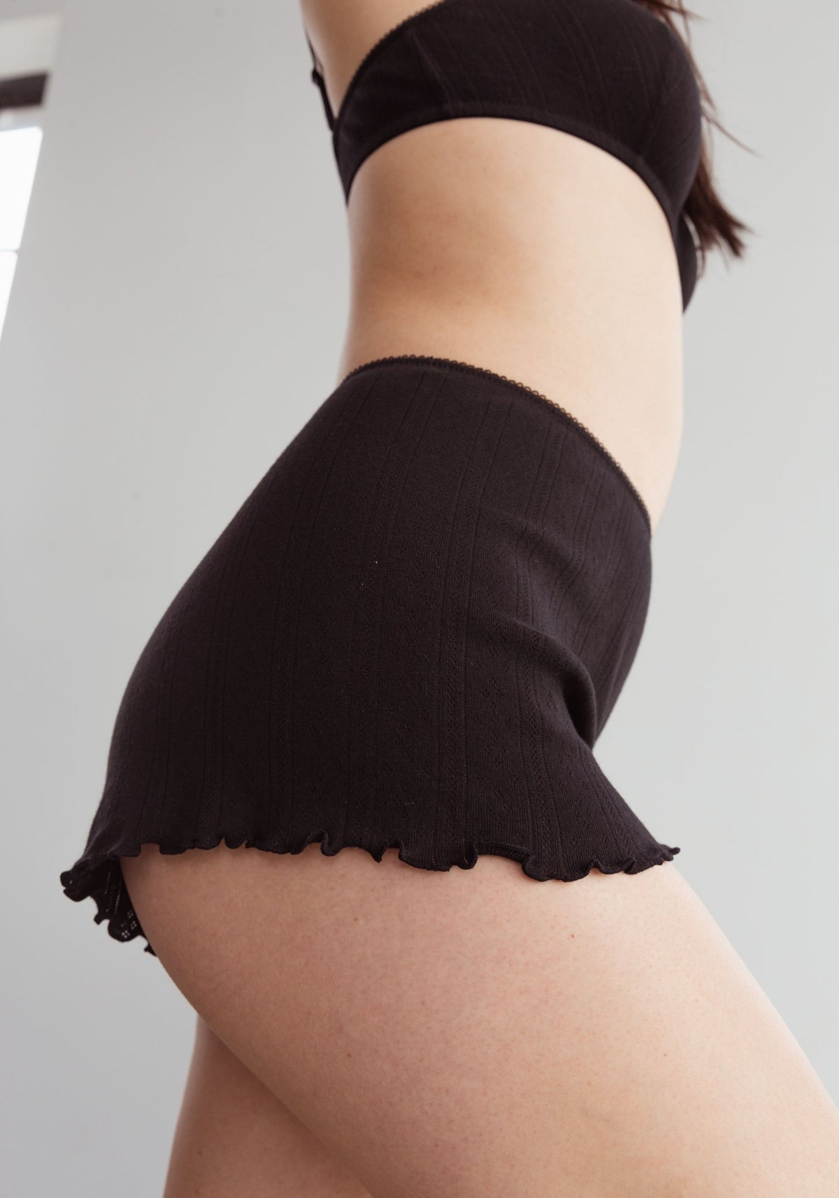model is wearing an S short - black dream cotton pointelle short
