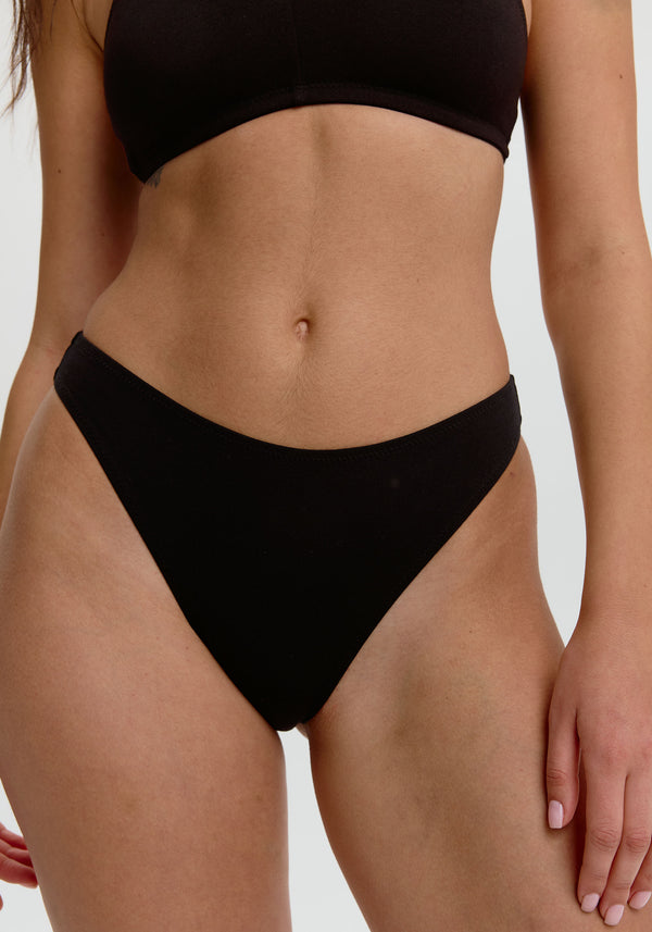 model is wearing an S panty-black the cotton high leg bikini