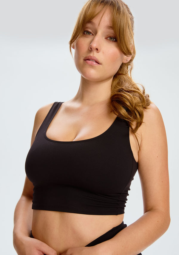 model is wearing an S tank-black core crop tank