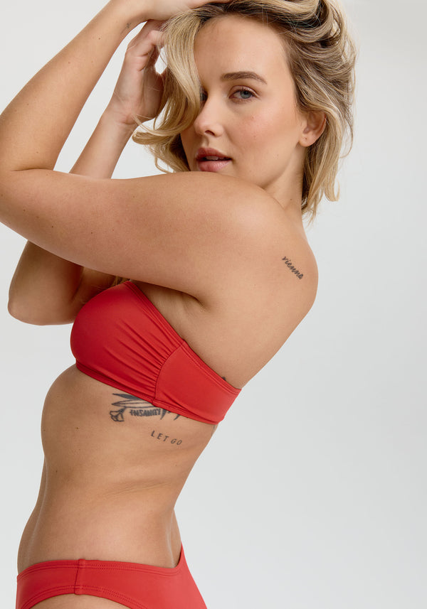 model is wearing an S bikini top - red laguna bandeau bikini top
