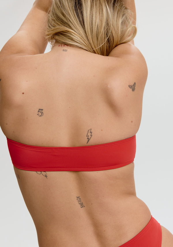 model is wearing an S bikini top - red laguna bandeau bikini top