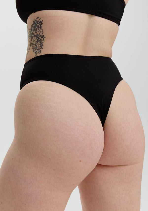 model is wearing an S bikini bottom - black belize high waist thong bikini bottom