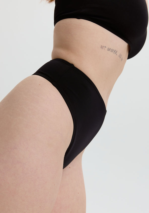 model is wearing an S bikini bottom - black belize high waist thong bikini bottom