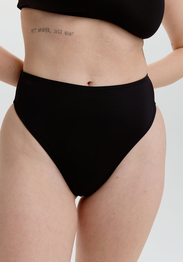 model is wearing an S bikini bottom - black belize high waist thong bikini bottom