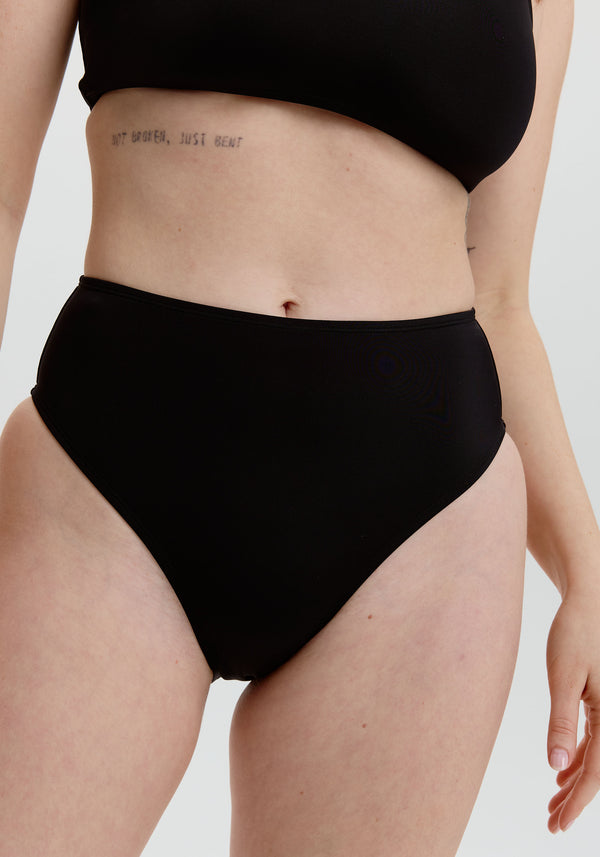model is wearing an S bikini bottom - black drift high waist bikini bottom