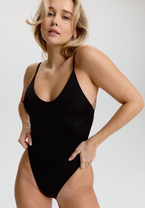 model is wearing an S one-piece swimsuit - black dawn scoop one-piece swimsuit