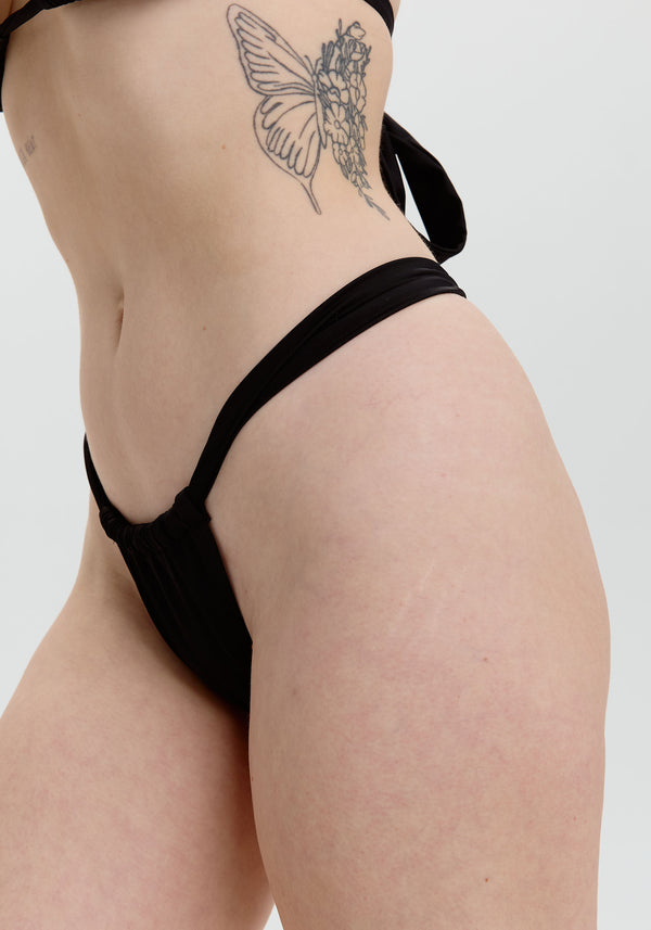 model is wearing an S bikini bottom - black breeze cheeky bikini bottom