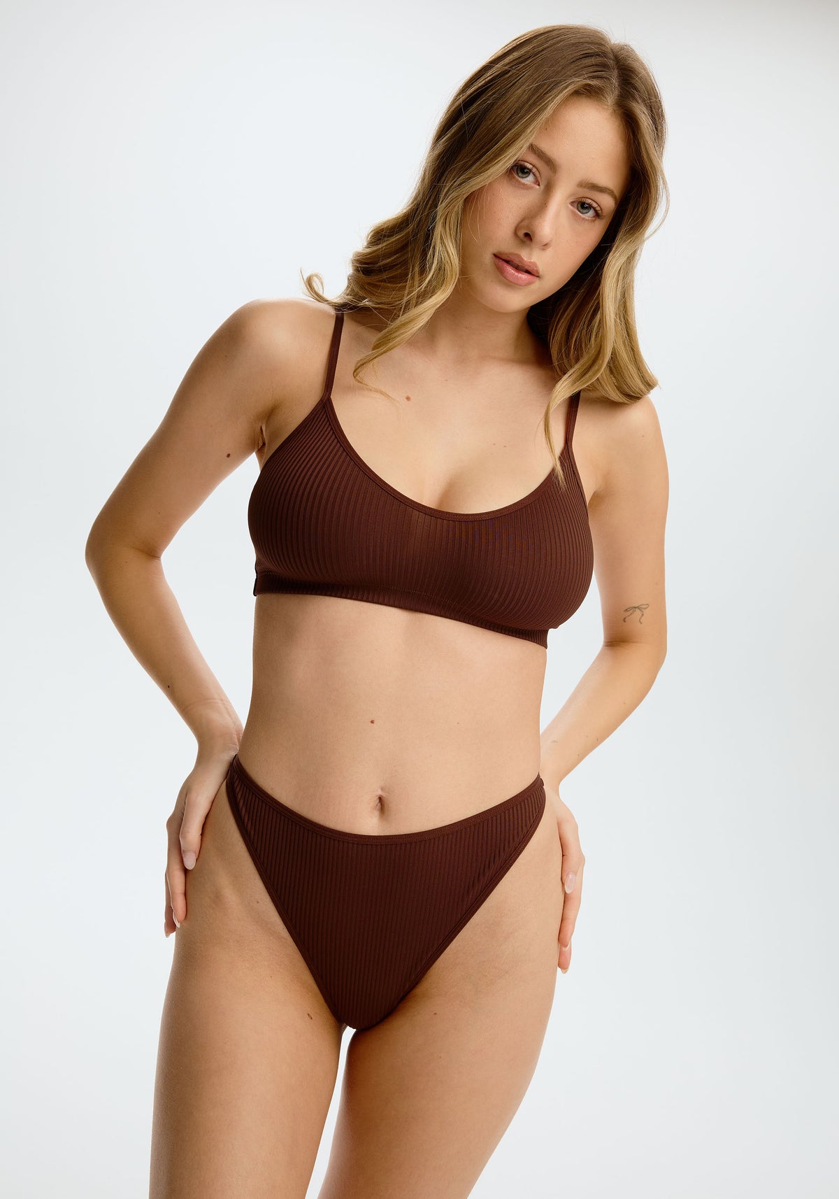 model is wearing an S panty - brown the rib high leg thong
