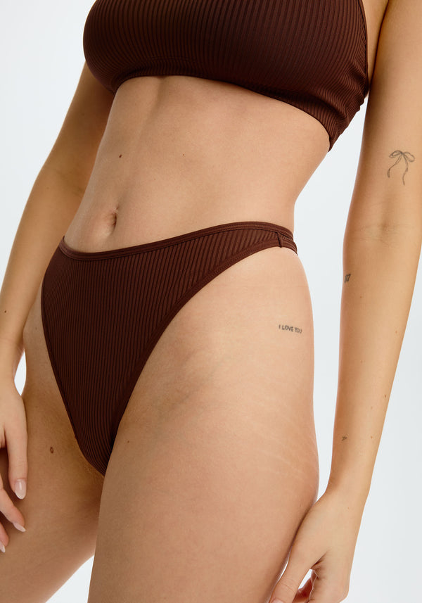 model is wearing an S panty - brown the rib high leg thong