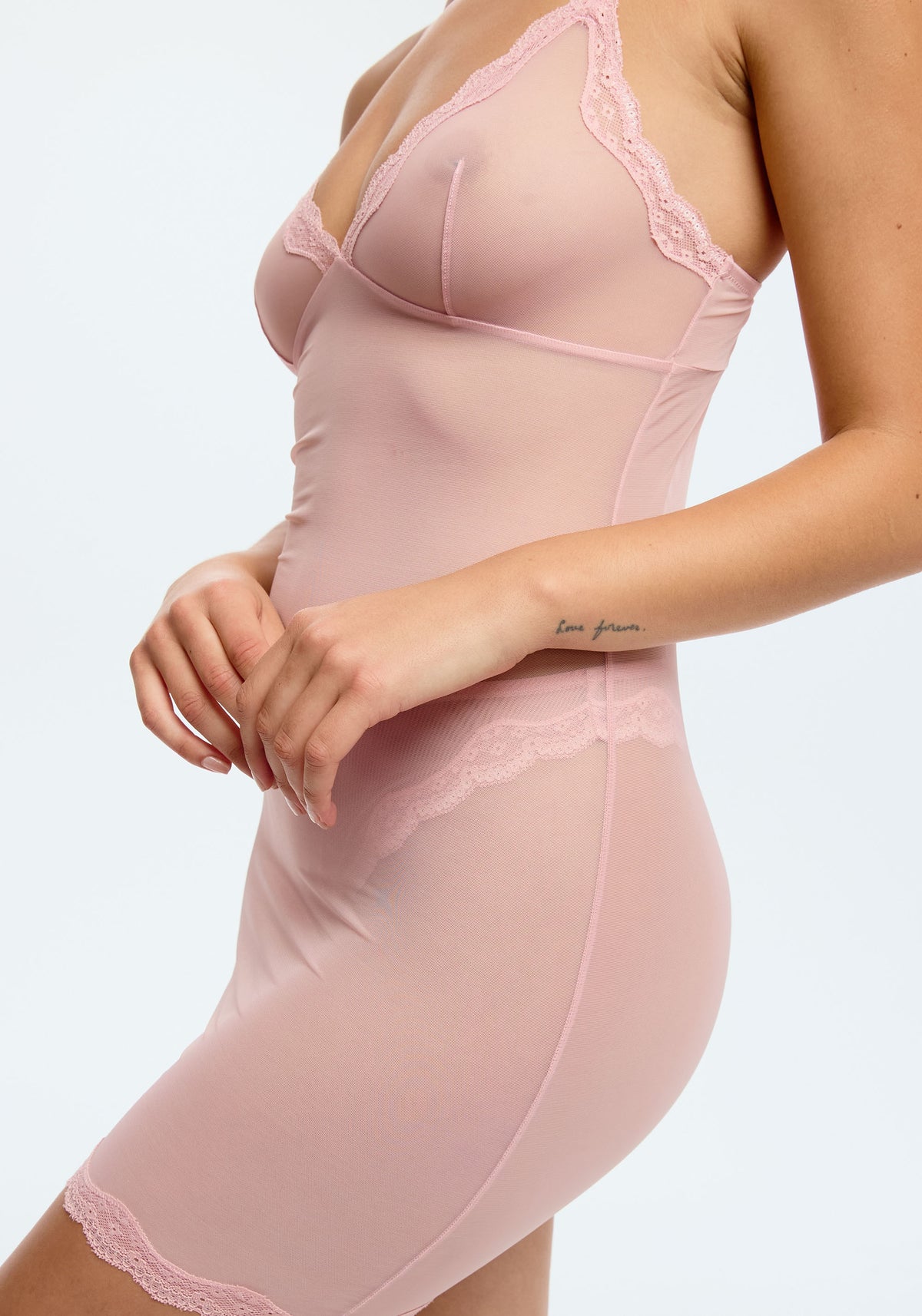 model is wearing an S slip-pink lotus slip