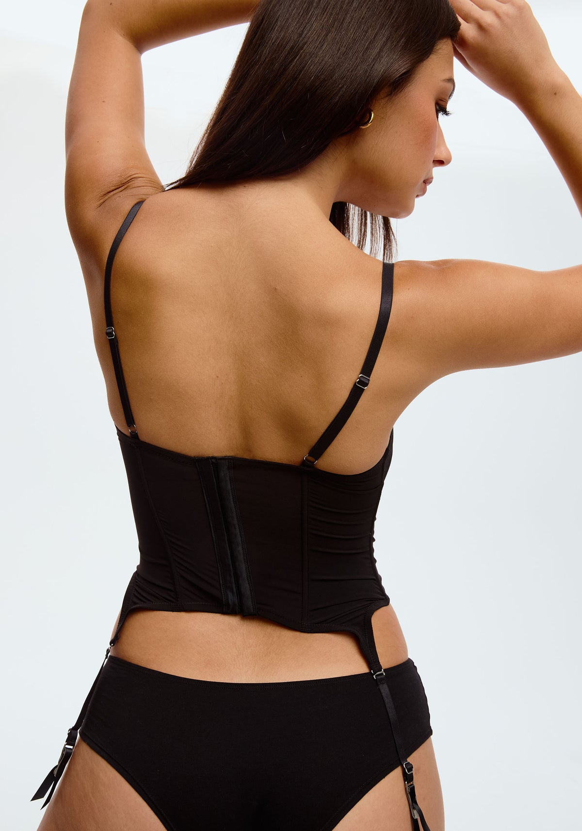 model is wearing an S corset-black orbit corset