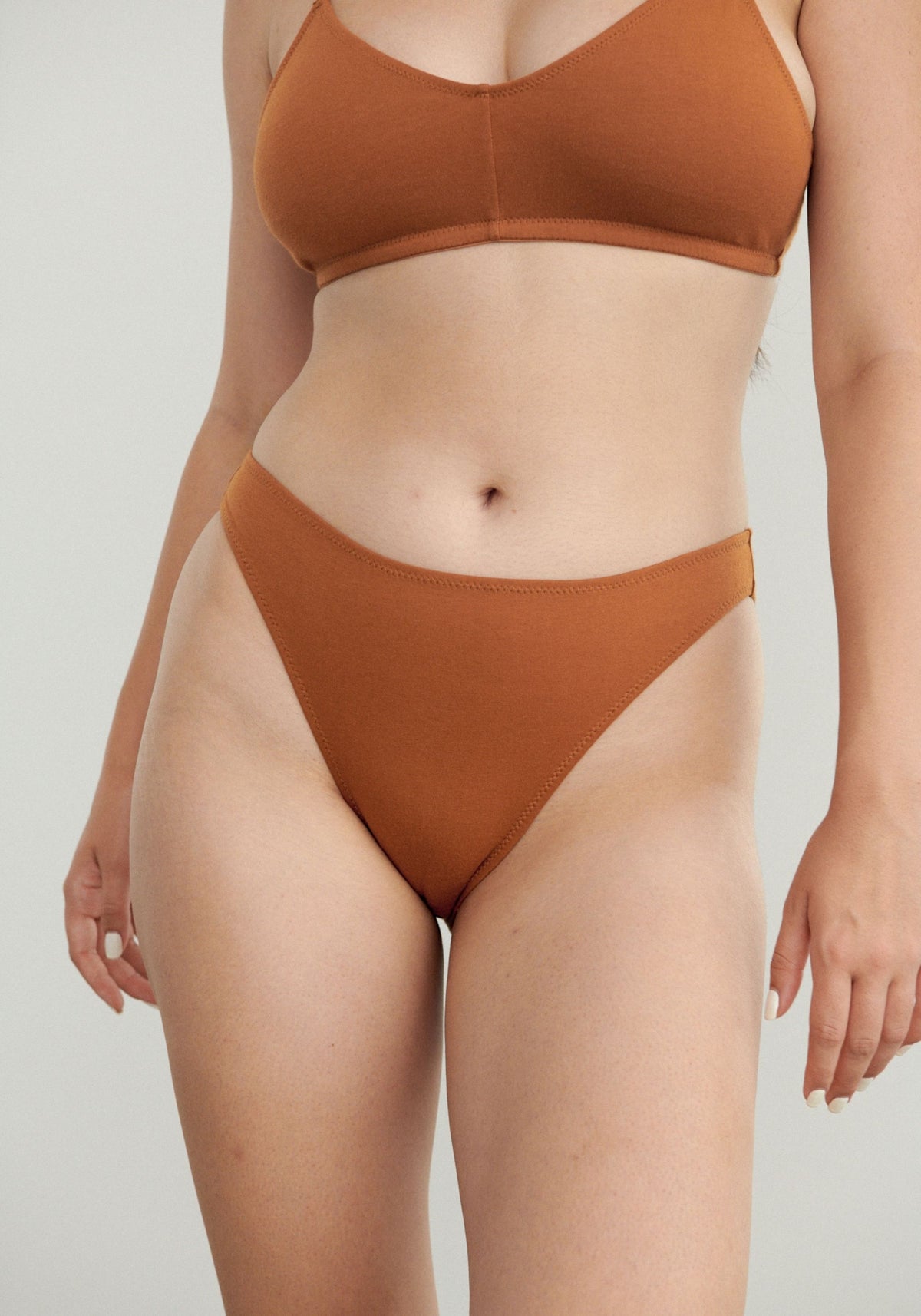 model is wearing an S panty-brown the cotton high leg bikini