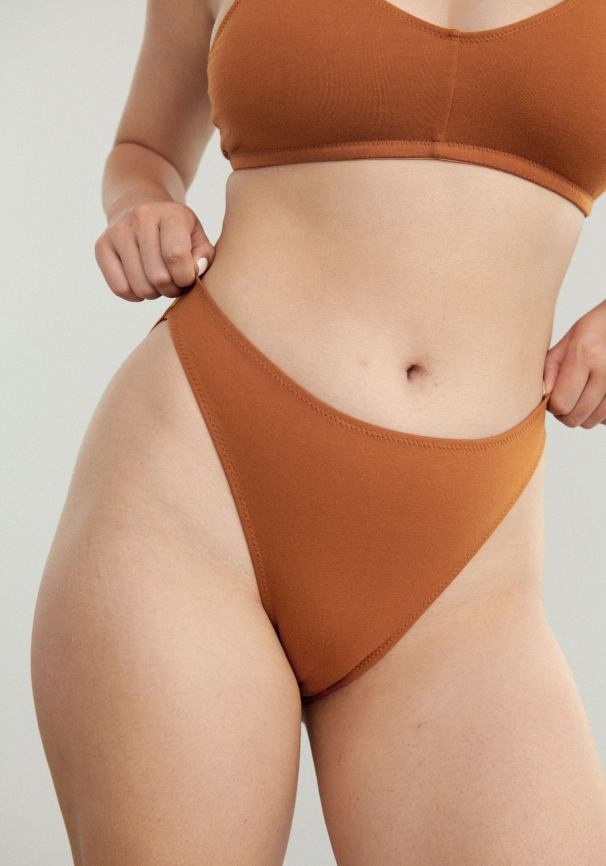 model is wearing an S panty-brown the cotton high leg bikini