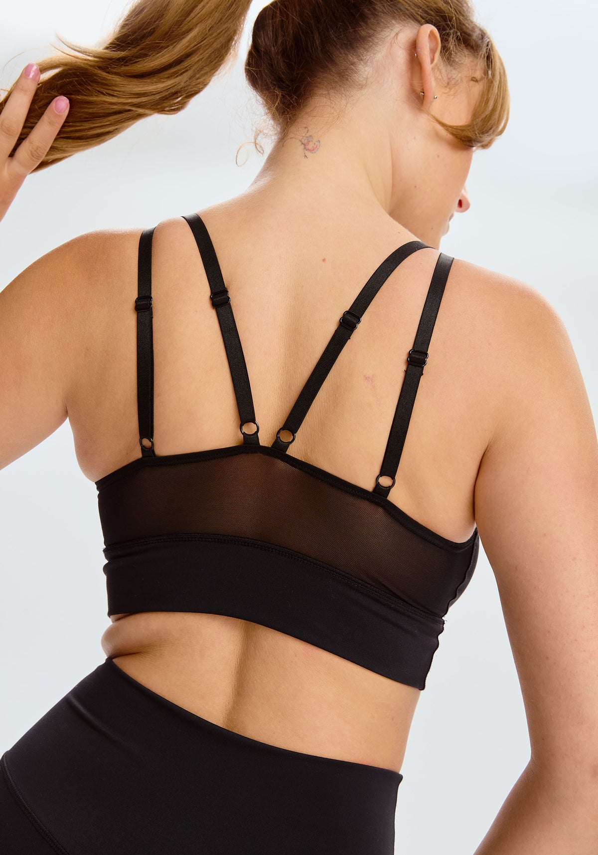 model is wearing an M sports bra-black pulse sports bra