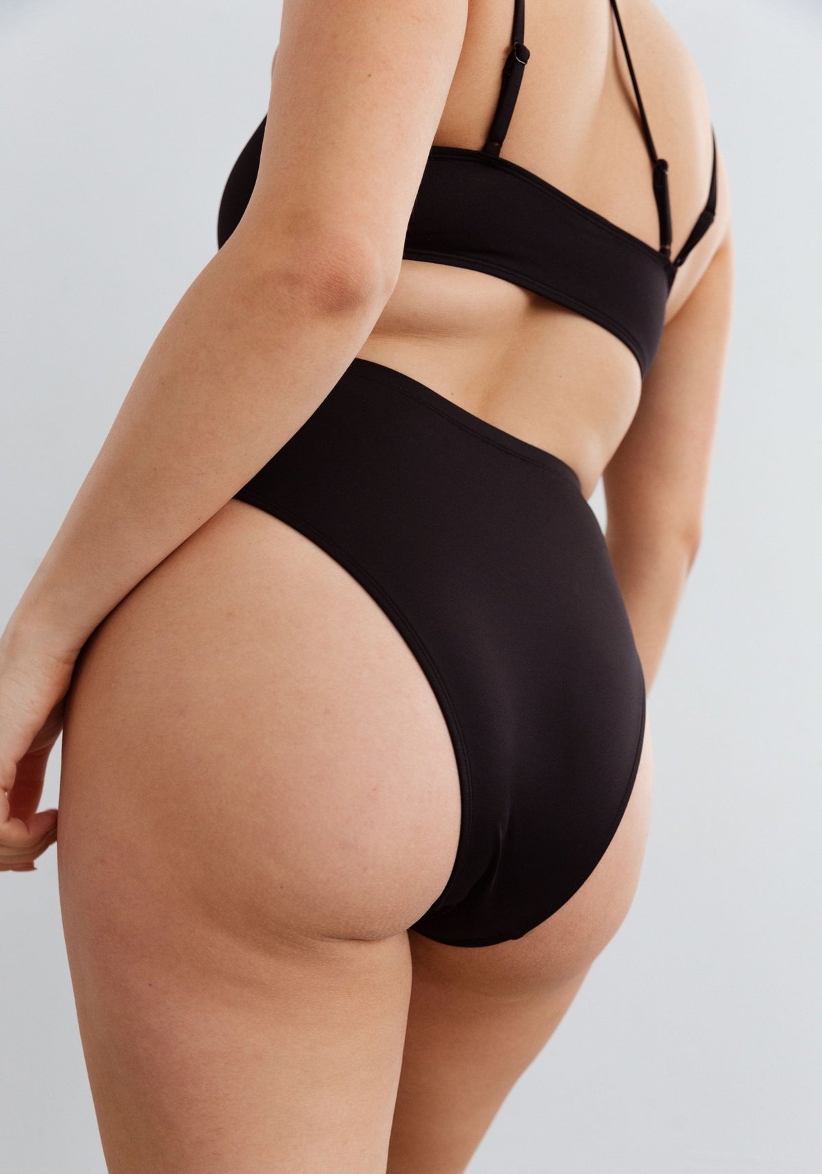 model is wearing an M bikini bottom-black mirage high waist bikini bottom