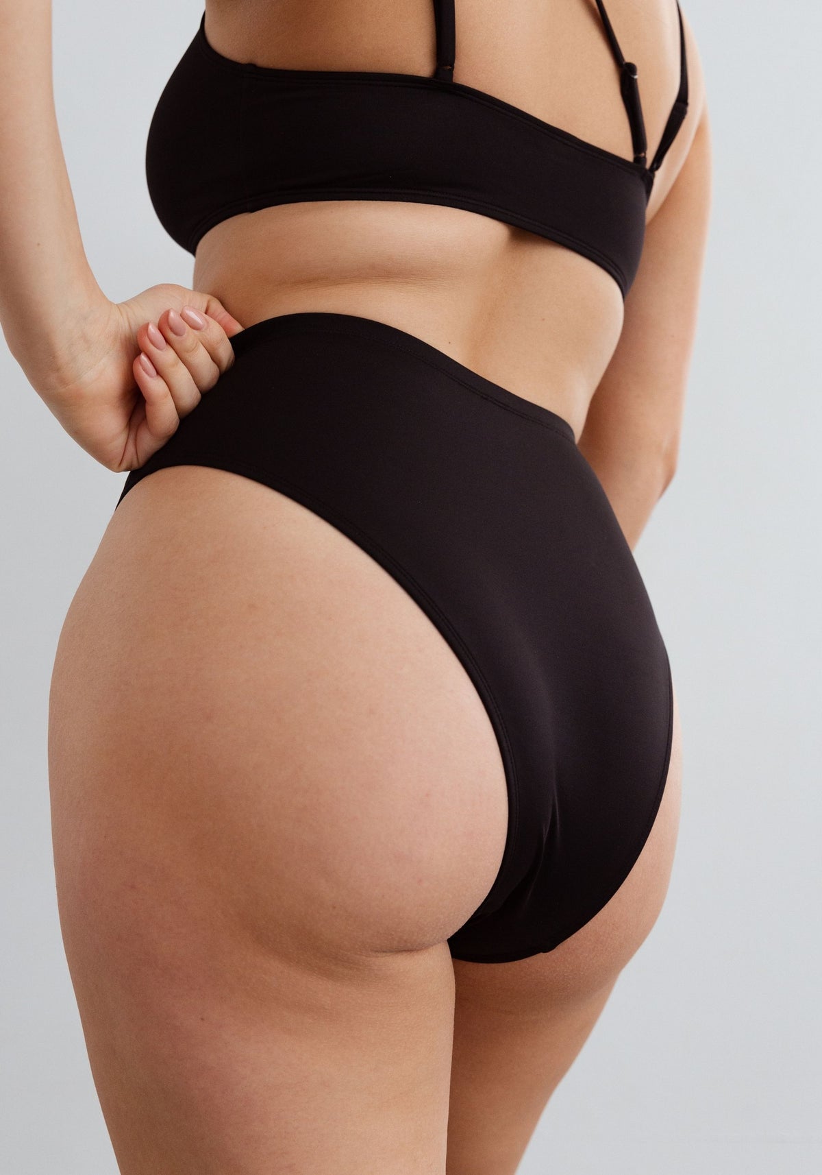 model is wearing an M bikini bottom-black mirage high waist bikini bottom