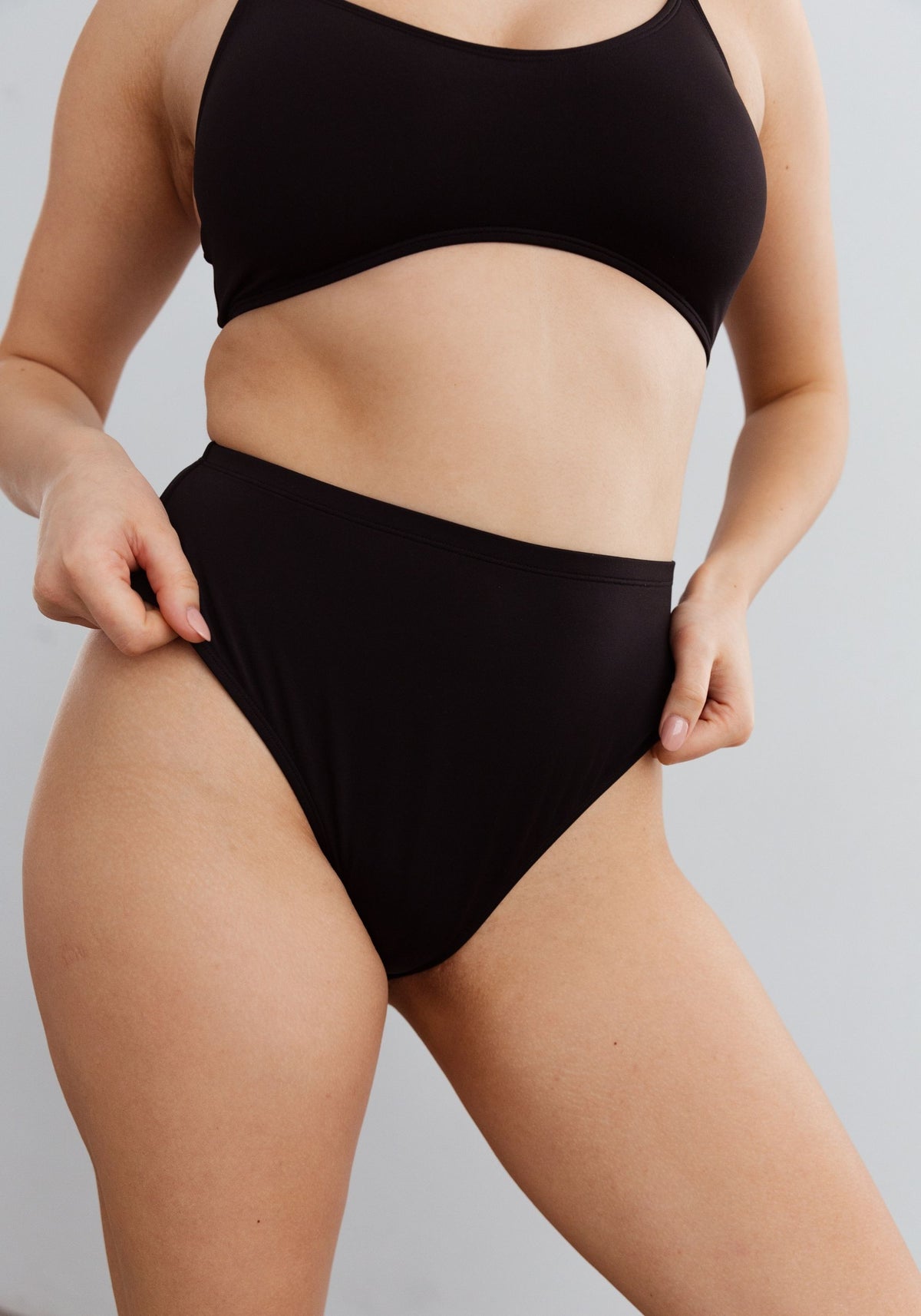 model is wearing an M bikini bottom-black mirage high waist bikini bottom