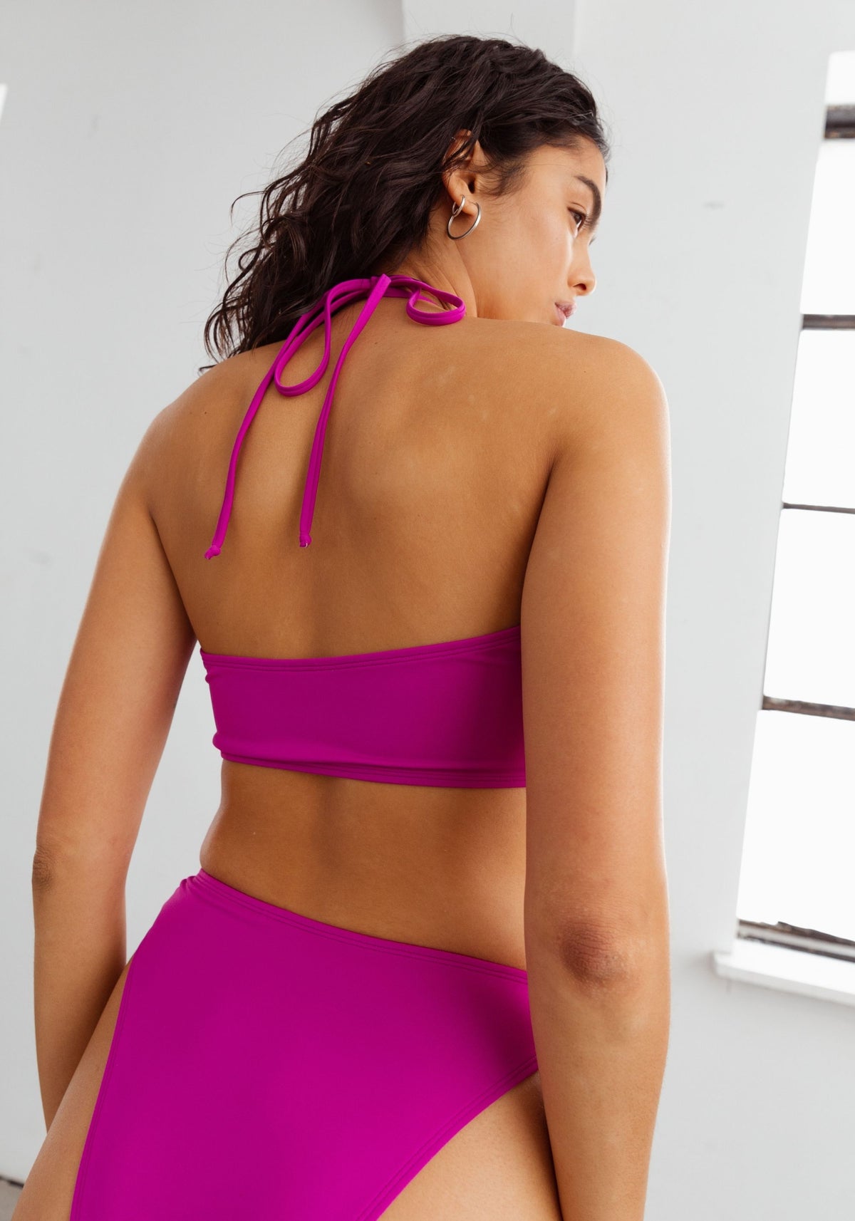model is wearing an S bikini top-pink,purple palm bandeau bikini top