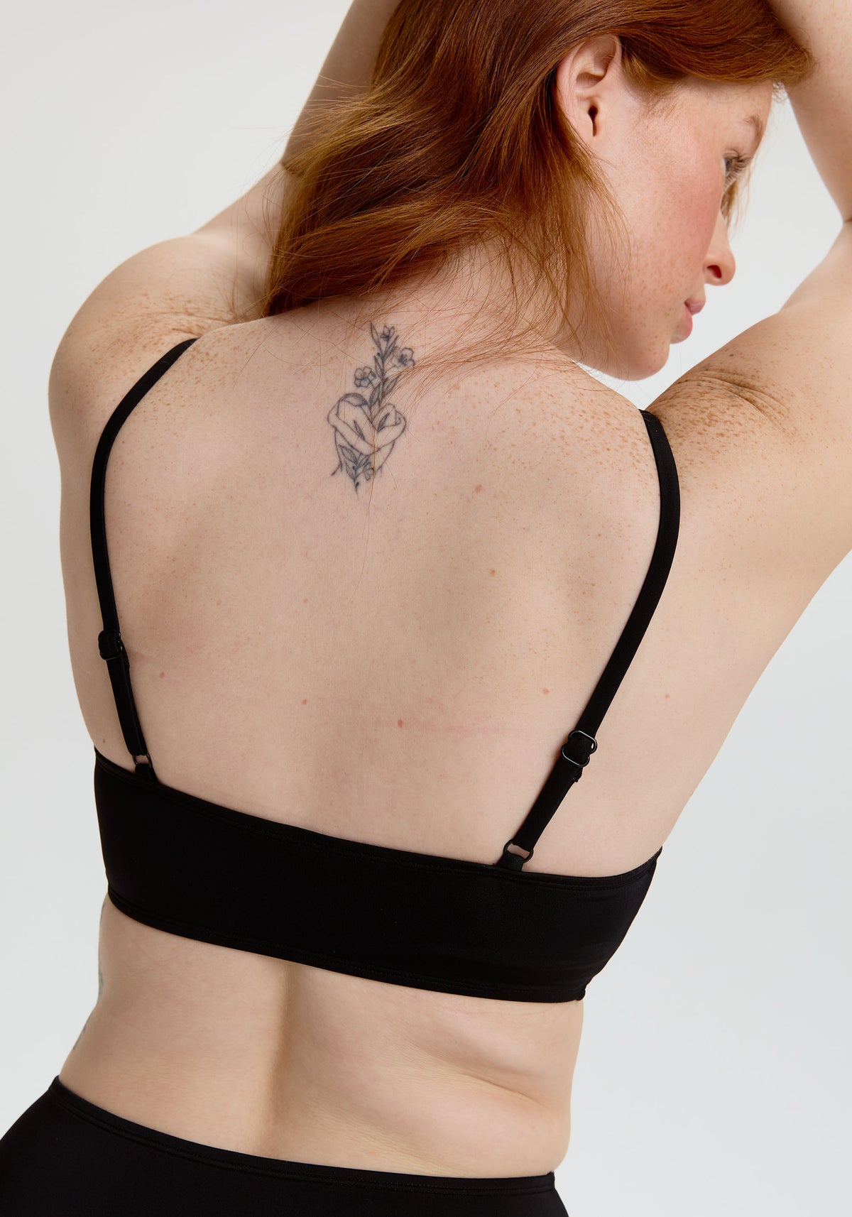 model is wearing an S+ bikini top - black tide scoop bikini top