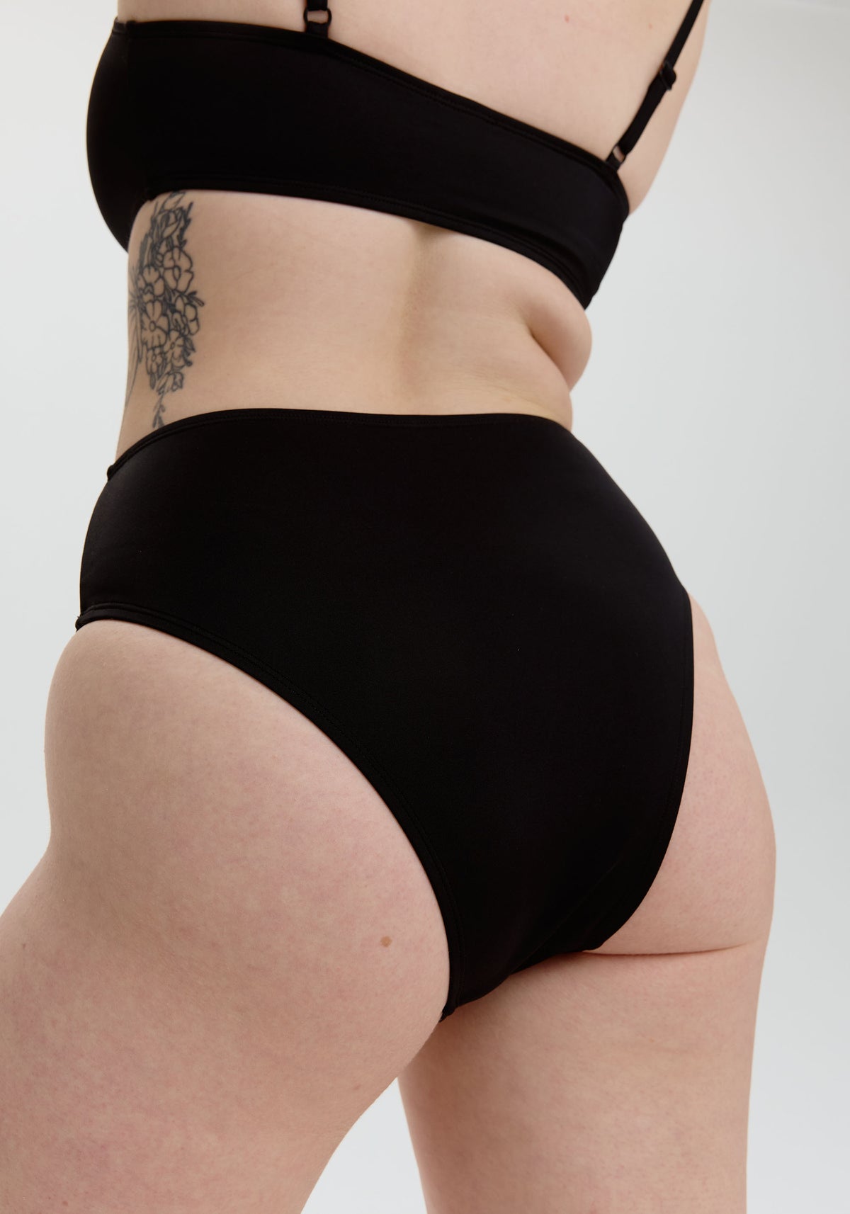 model is wearing an S bikini bottom - black drift high waist bikini bottom