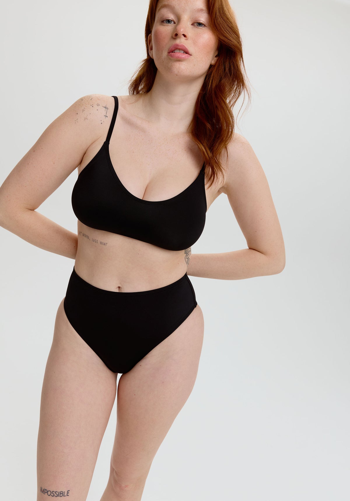 model is wearing an S bikini bottom - black drift high waist bikini bottom