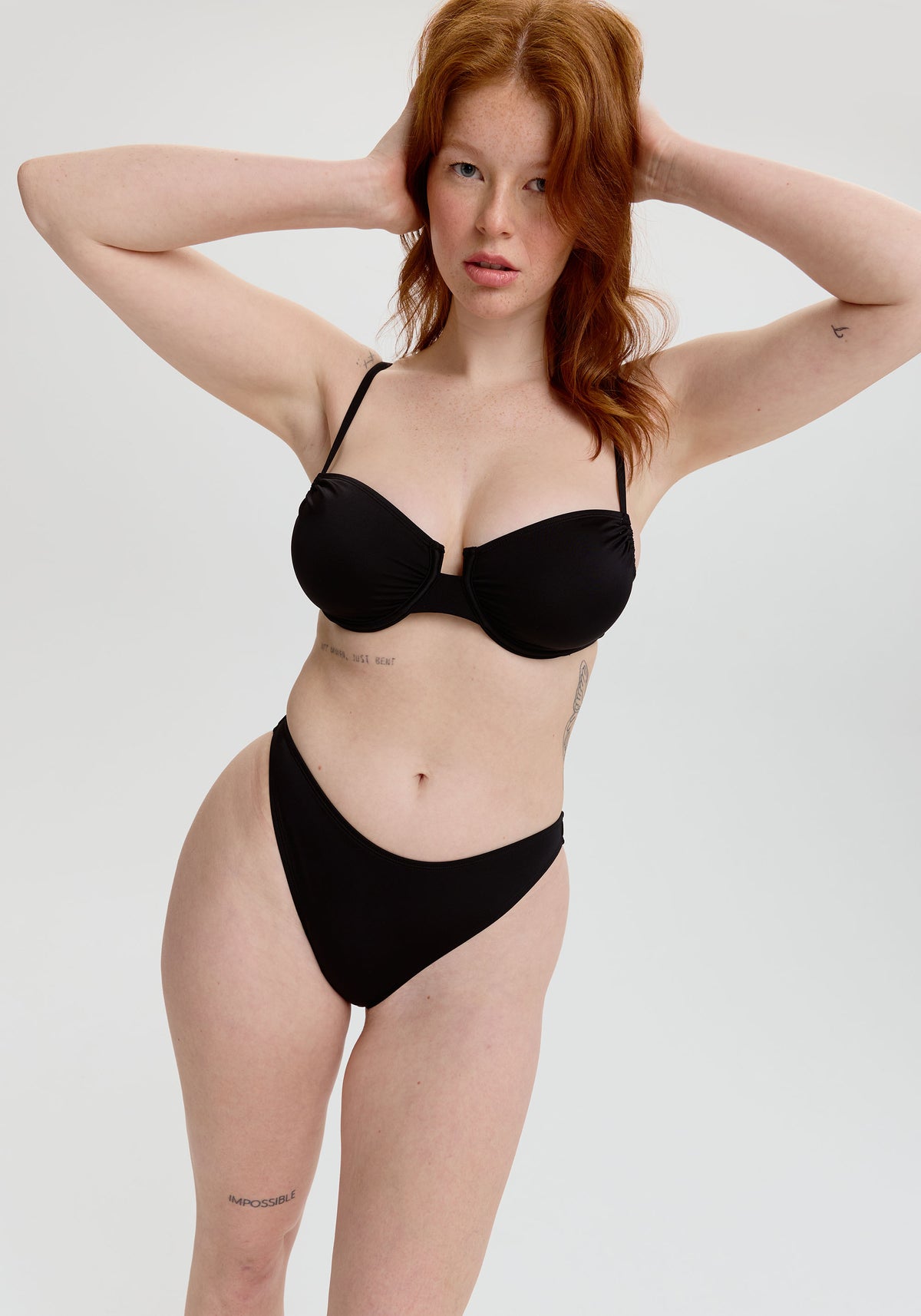 model is wearing an S bikini bottom - black capri high leg bikini bottom