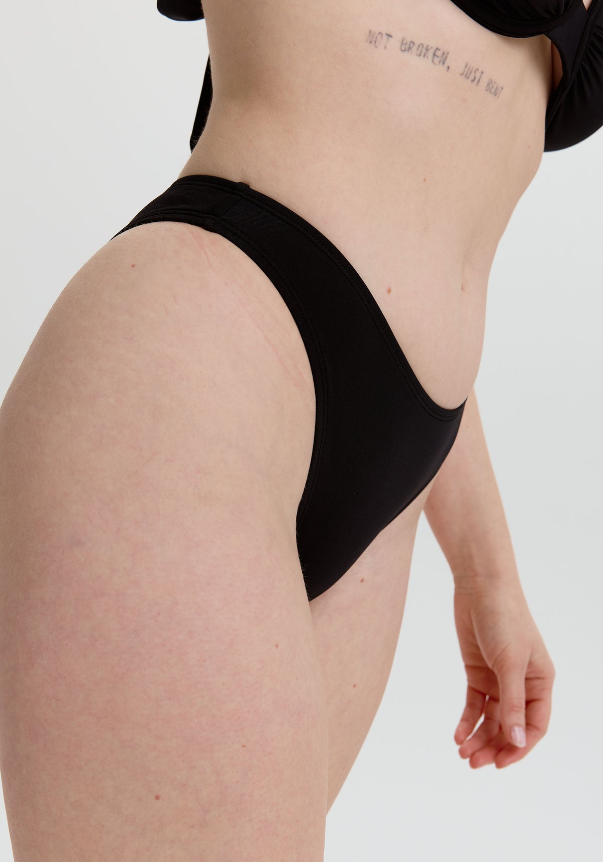 model is wearing an S bikini bottom - black capri high leg bikini bottom