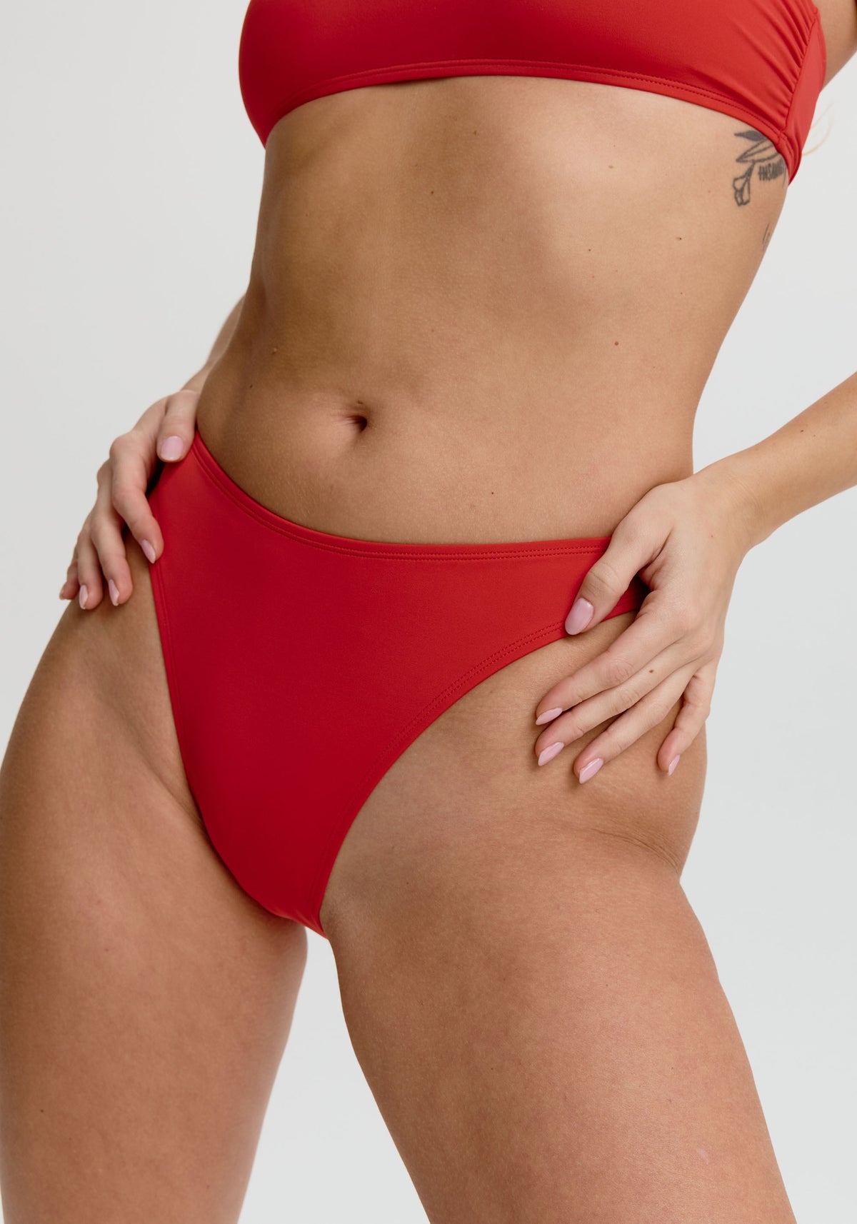 model is wearing an S bikini bottom - red capri high leg bikini bottom