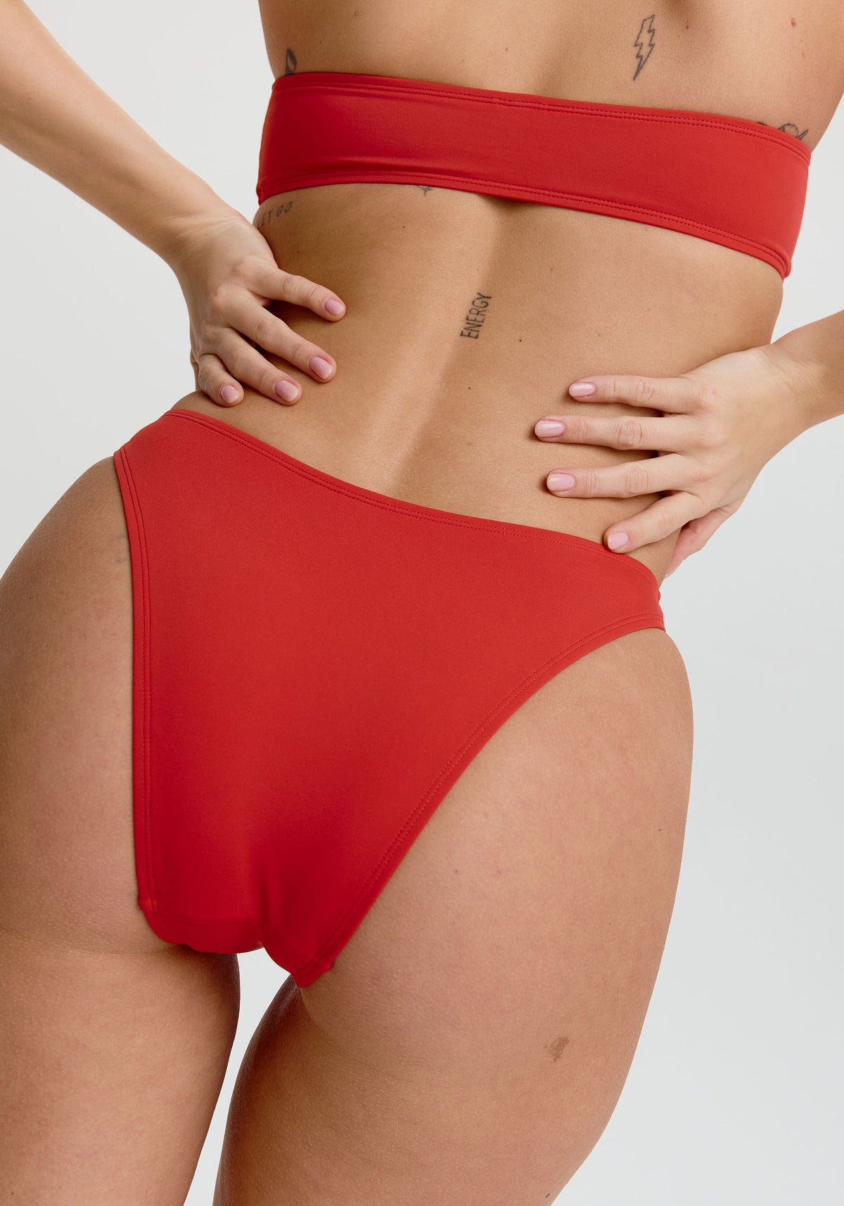 model is wearing an S bikini bottom - red capri high leg bikini bottom