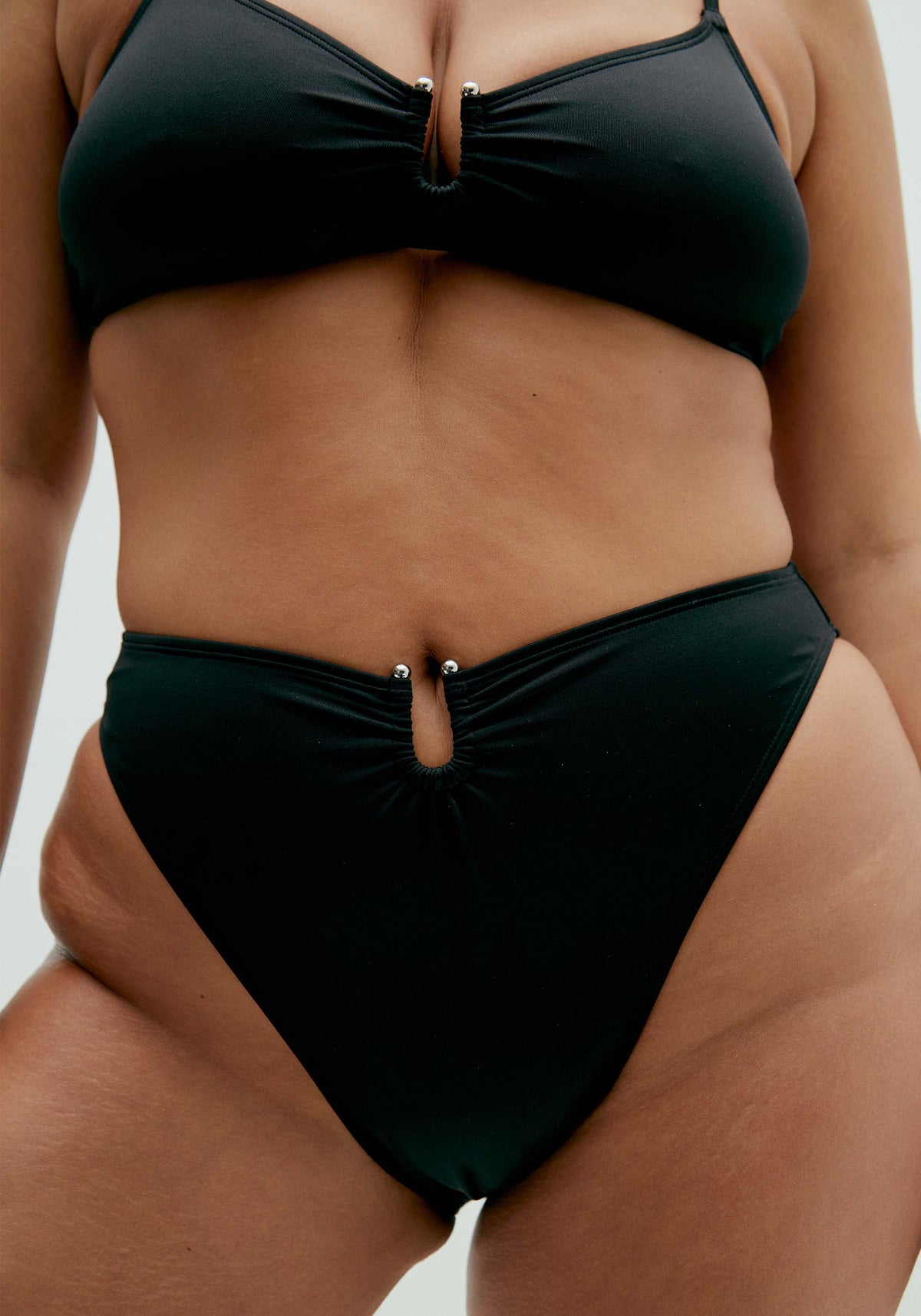 model is wearing an L bikini bottom-black solstice high leg bikini bottom