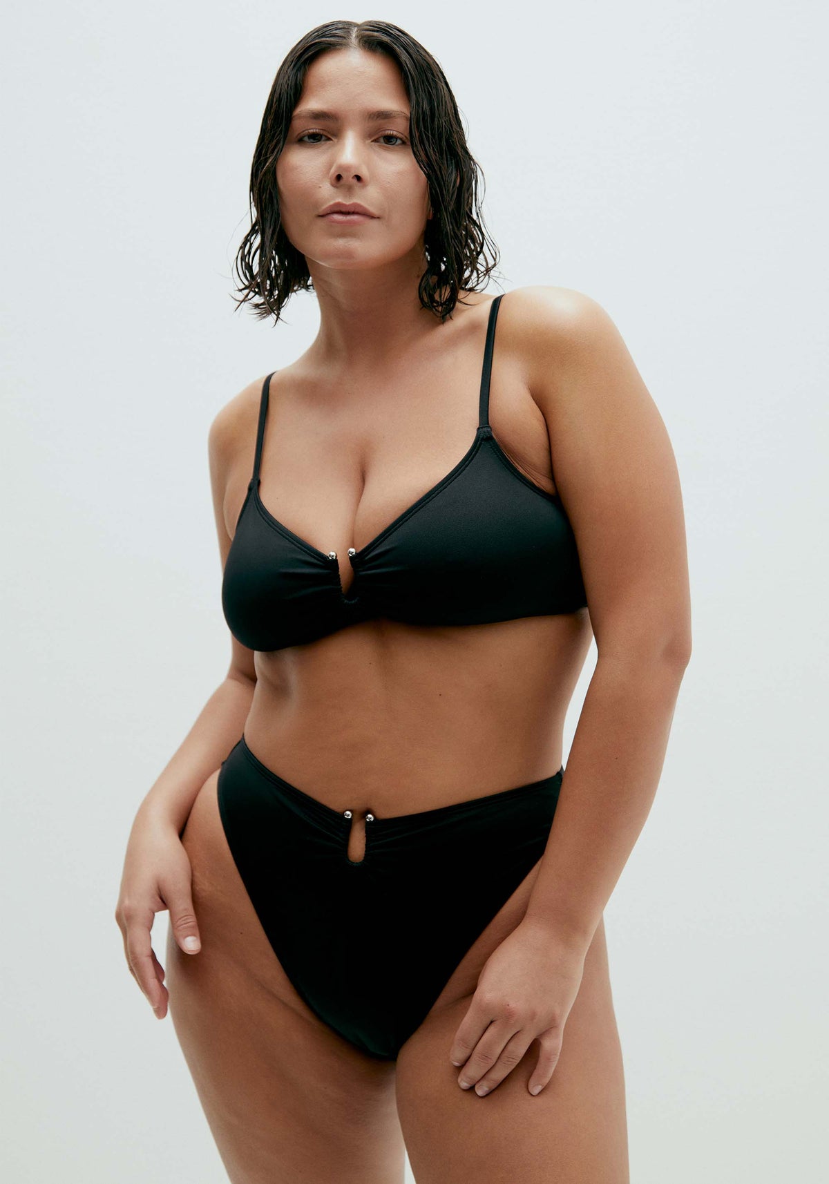 model is wearing an L bikini bottom-black solstice high leg bikini bottom