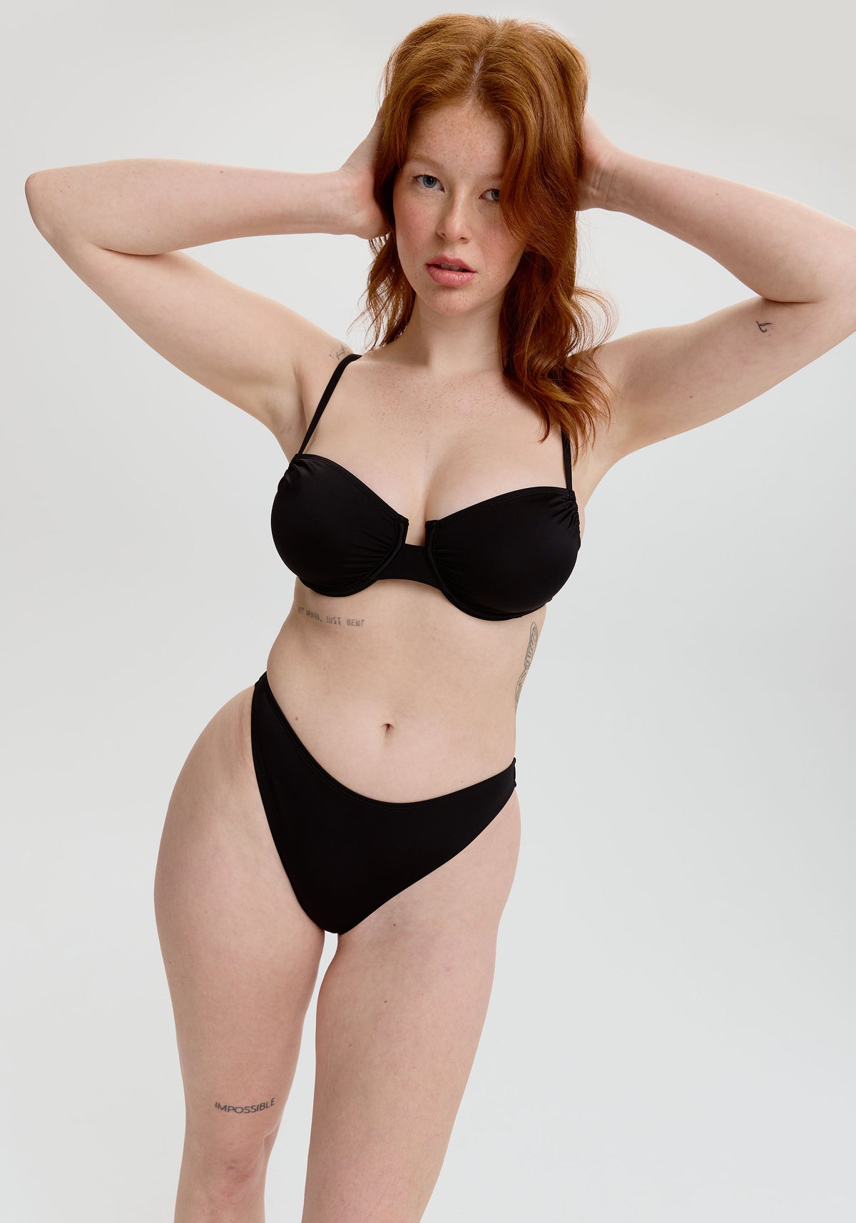 model is wearing an S+ bikini top - black malta underwire bikini top