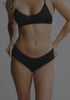 model is wearing an S panty - black the micro lace trim hipster