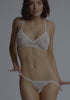 model is wearing an XS panty - white cascade string thong