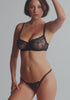 model is wearing an S panty - black enchant string thong