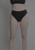 model is wearing an S bikini bottom - black drift high waist bikini bottom